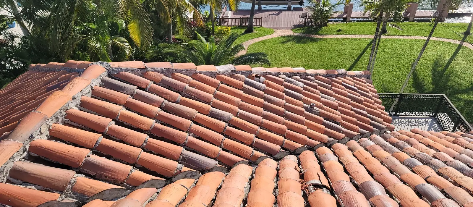 Close-up of red clay S-tiles showing classic barrel profile