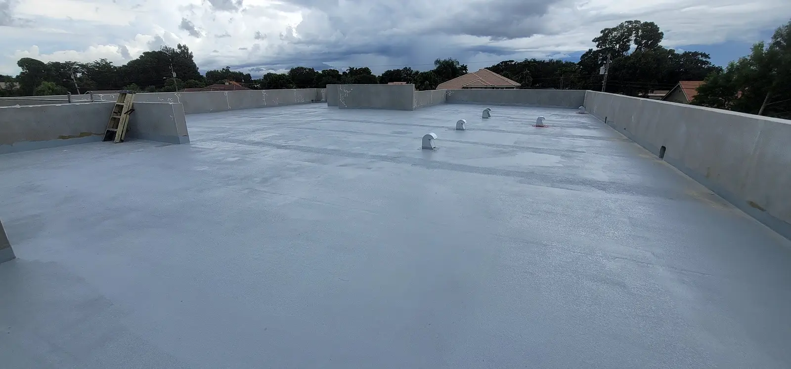 Planet Roofing commercial team inspecting completed TPO flat roof in Fort Lauderdale