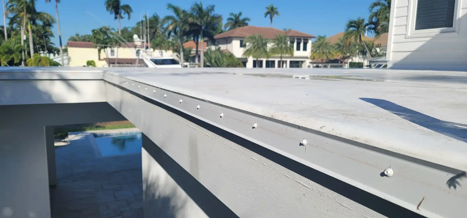 Drip edge metal detail on a TPO roof showing welded seam