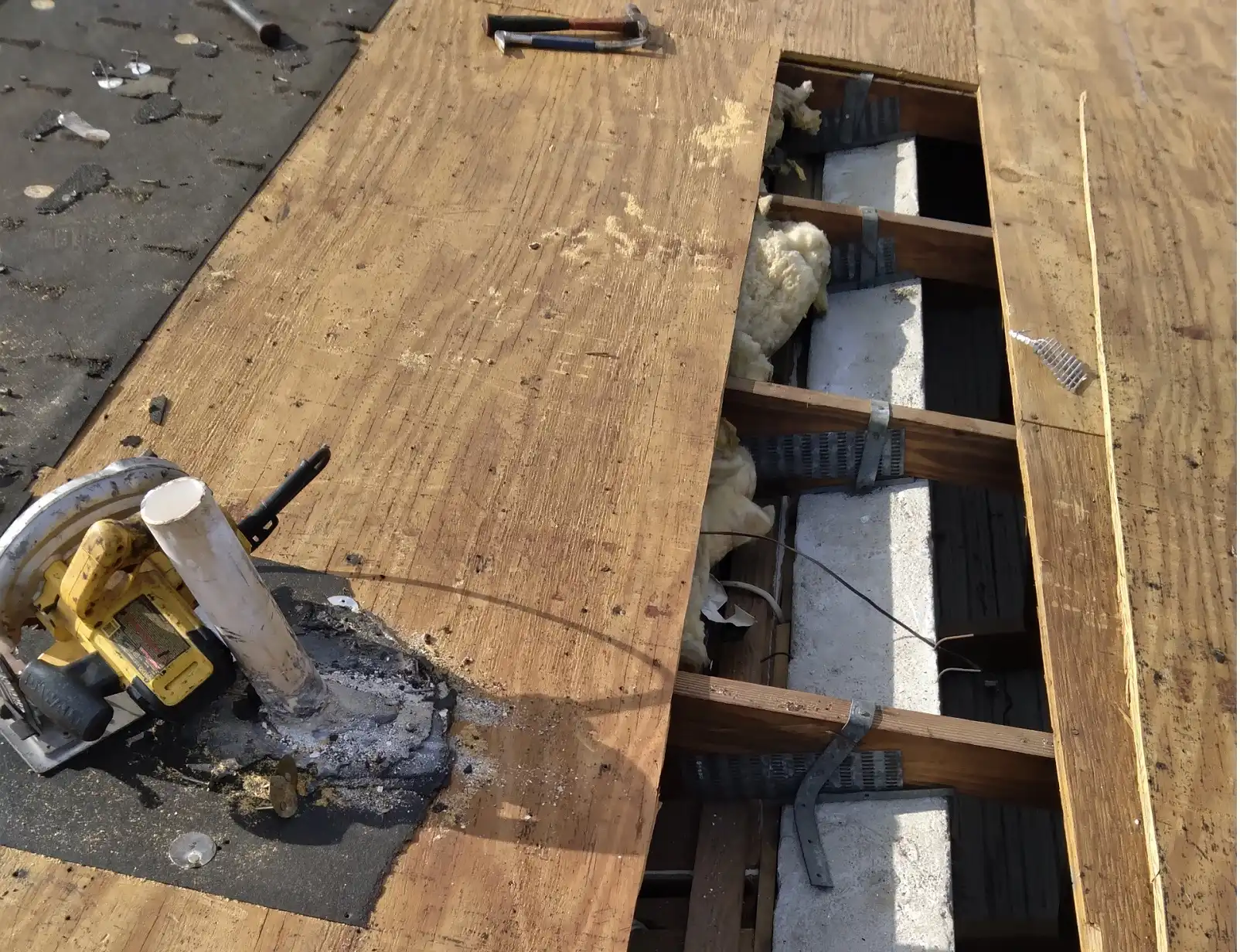 Planet Roofing crew member cleaning concrete roof tiles to prevent mold growth in Fort Lauderdale FL