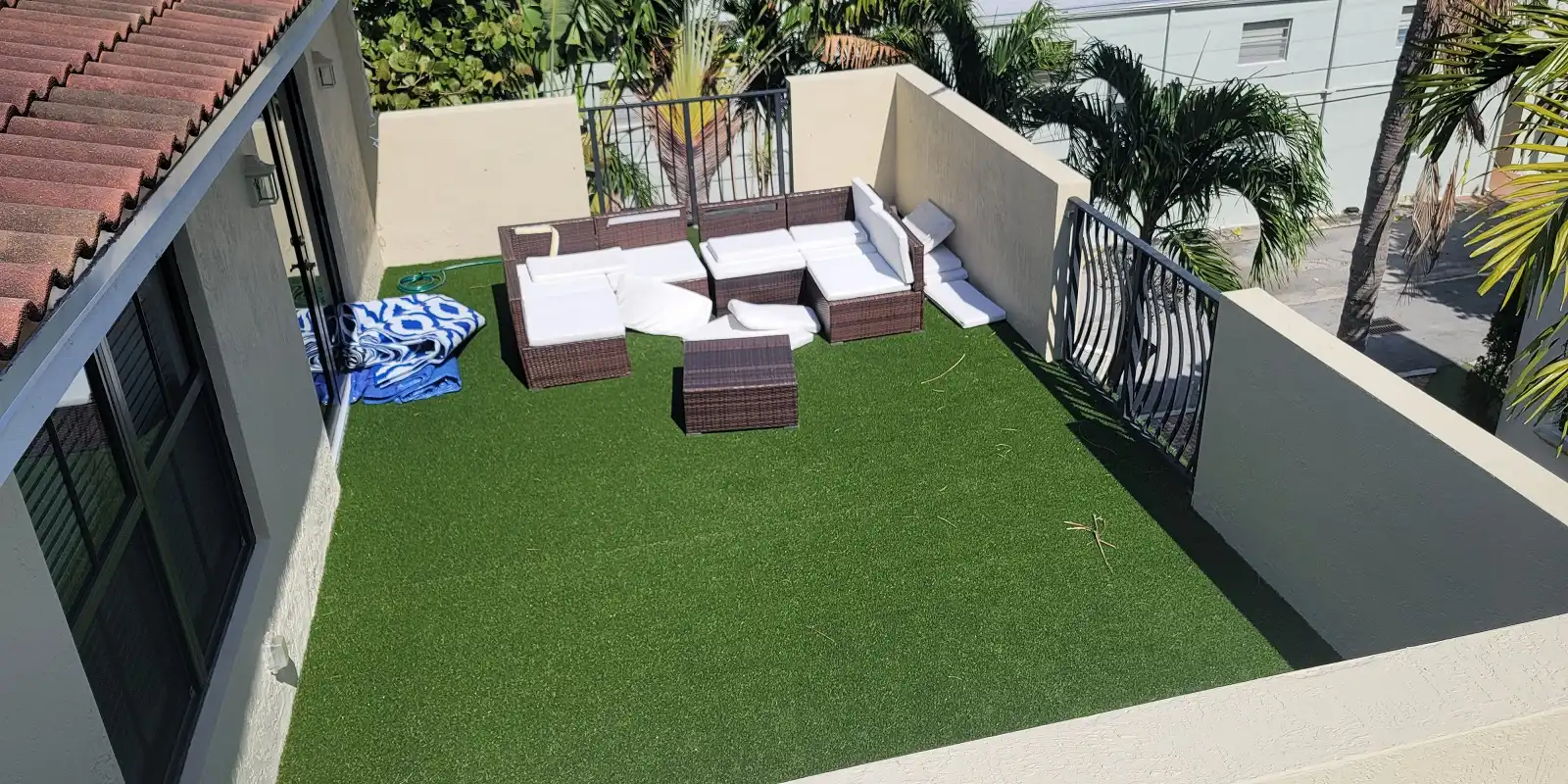 Completed waterproofed patio deck featuring a seamless gray coating on a Fort Lauderdale residential property