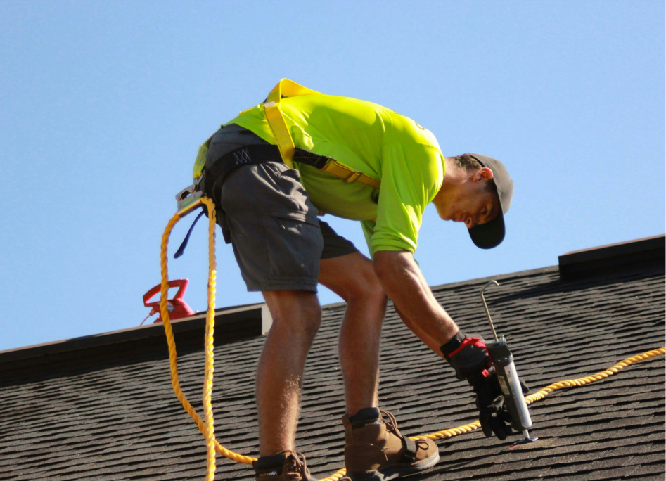 A man putting on a sealant in a roof in florida