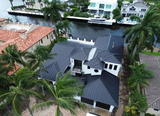 Standing seam metal roof made of dark aluminum, featuring sleek, durable panels.