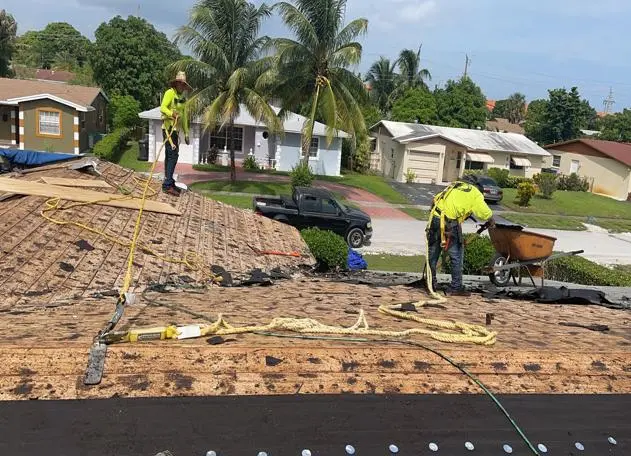 crew two men in roof tear off in progress for a roofing project in florida for planet roofing