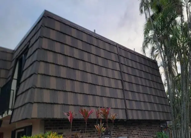 Stone-coated steel roof installed on a mansard flat roof, providing durability and a stylish finish.