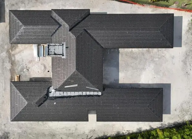 Underlayment being installed for a tile roof during new house construction for added protection.