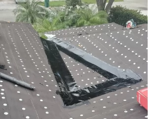 New roof underlayment being installed with flashing