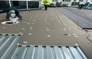 Corrugated metal panels being installed as a roof deck