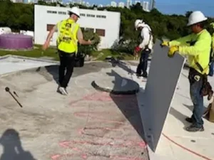 Planet Roofing crew wearing safety gear with license and insurance certificates on display